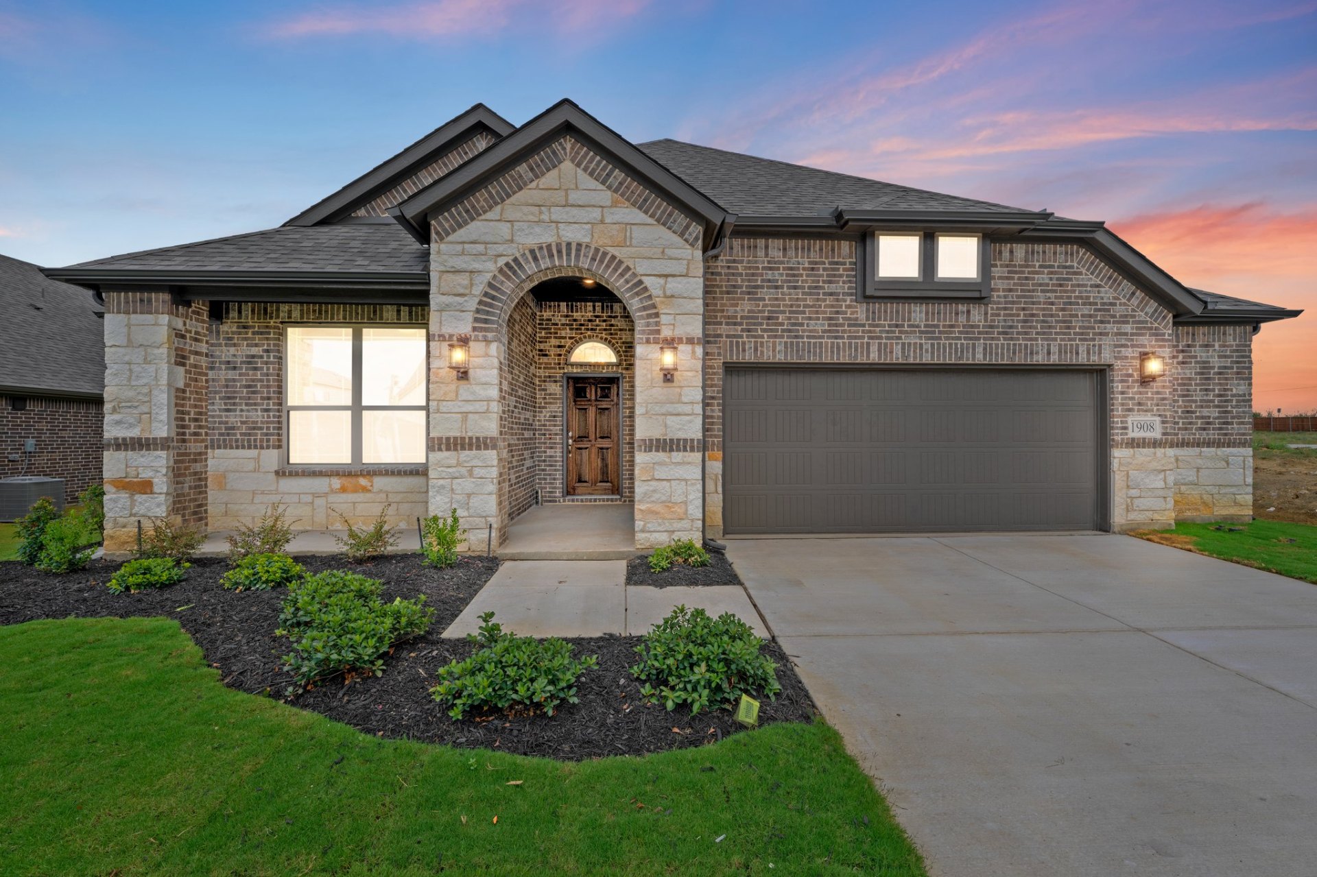 Biltmore Homes — Fremont plan at Horizons at Venus — arched stone entry
