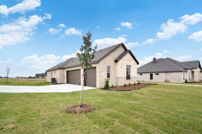 Silverleaf Homes — Stone & brick exterior with mature landscaping