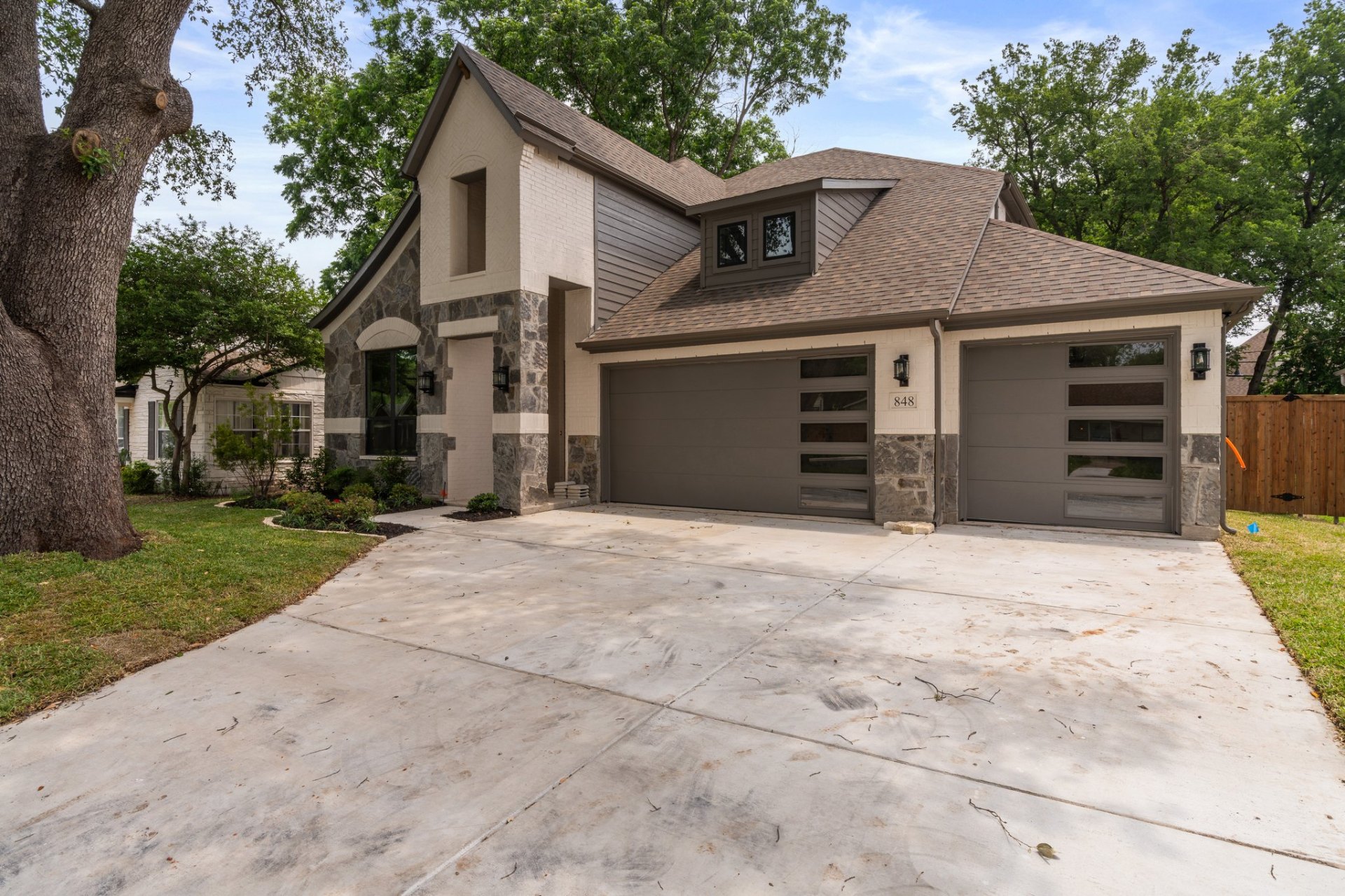 Biltmore Homes — Northwood plan in Regatta Oaks — stone & stucco exterior